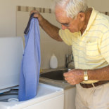 elder man doing laundry