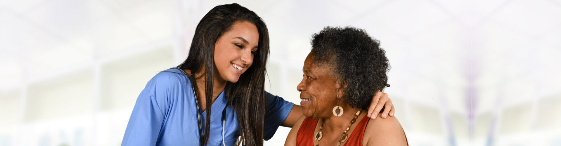 elder woman with caregiver looking at each other